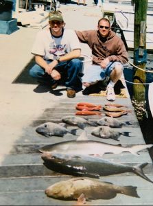 Mark and his best friend Matt showing off their catch of the day. 