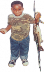 Jeremy Hilliard holding a fish as a toddler