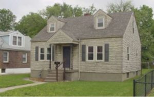 A 2 story grey and brown brick house